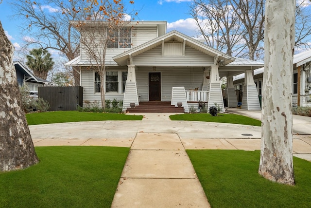 view of front of house featuring a front yard and covered porch