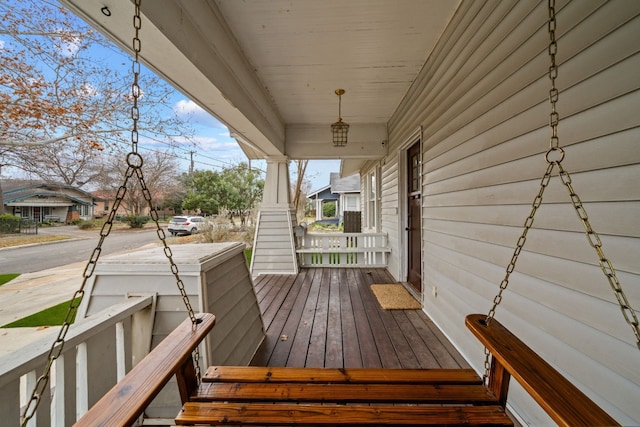 wooden terrace featuring covered porch