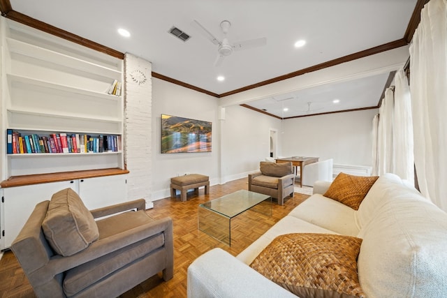 living room with built in shelves, parquet flooring, ornamental molding, and ceiling fan