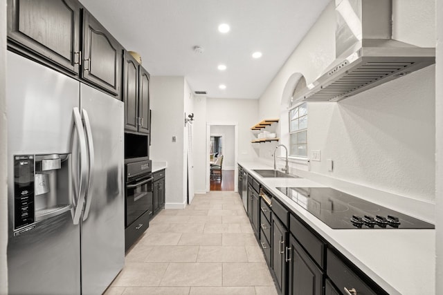 kitchen featuring sink, light tile patterned floors, black appliances, and exhaust hood