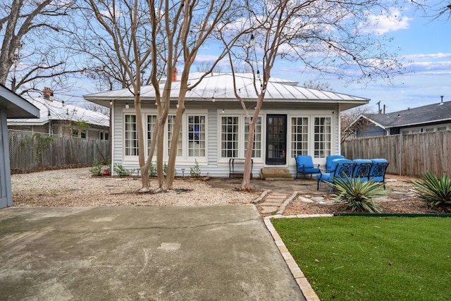 rear view of house with an outdoor living space, a lawn, and a patio