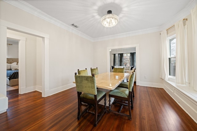 dining room featuring crown molding, a notable chandelier, and dark hardwood / wood-style flooring