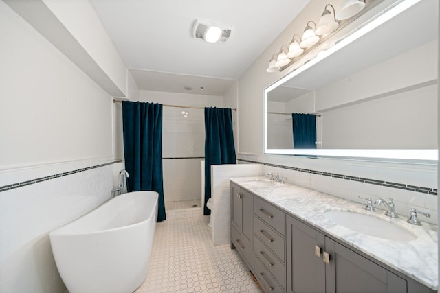 bathroom featuring tile walls, vanity, tile patterned floors, and separate shower and tub