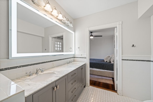 bathroom with vanity, tile walls, and ceiling fan