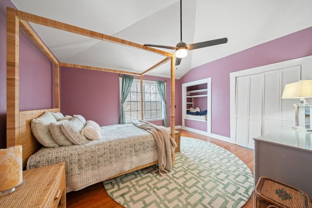 bedroom with ceiling fan, lofted ceiling, and wood-type flooring