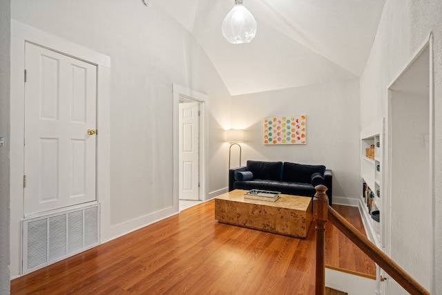 sitting room featuring lofted ceiling and hardwood / wood-style floors