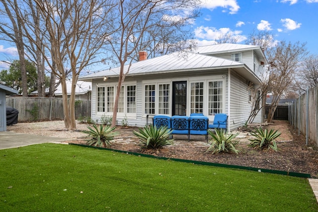 rear view of house featuring a lawn