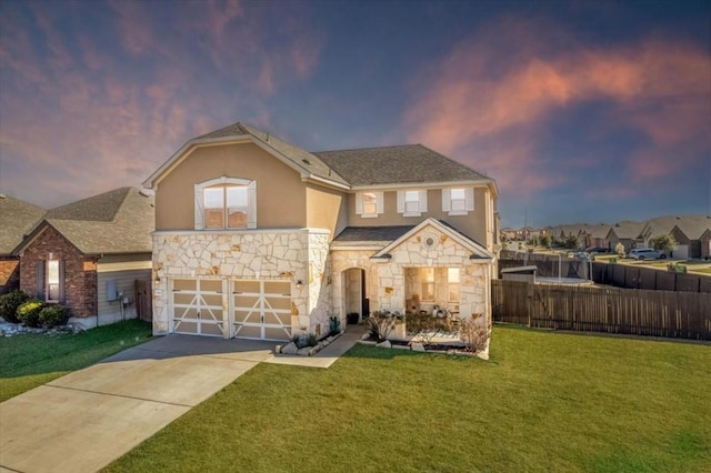 view of front of property with a yard and a garage