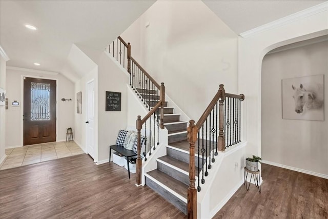 foyer with crown molding and hardwood / wood-style floors