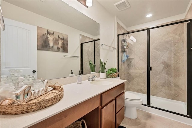 bathroom with vanity, walk in shower, and toilet