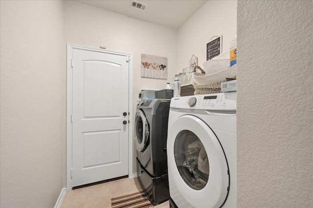 laundry room with light tile patterned floors and independent washer and dryer