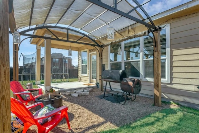 view of patio featuring a grill and a trampoline