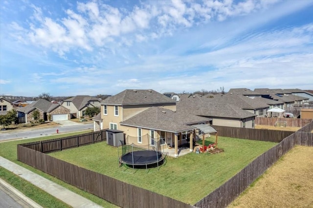 view of yard with a trampoline and a storage unit