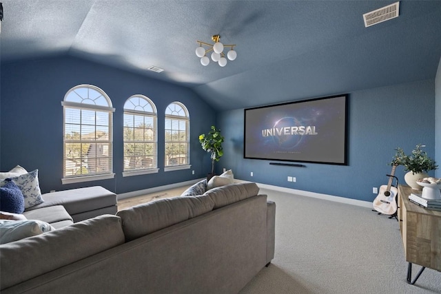 cinema room featuring lofted ceiling, carpet floors, and a textured ceiling