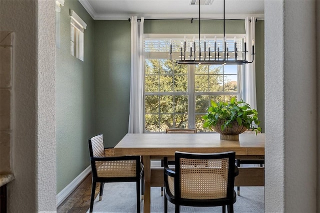 dining room with plenty of natural light and ornamental molding