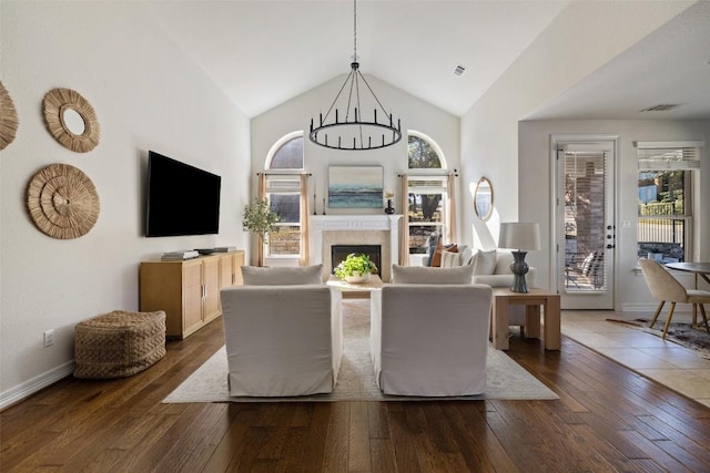 living room with dark wood-type flooring and high vaulted ceiling