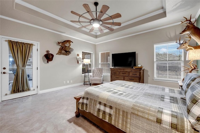 carpeted bedroom featuring crown molding, ceiling fan, and a tray ceiling