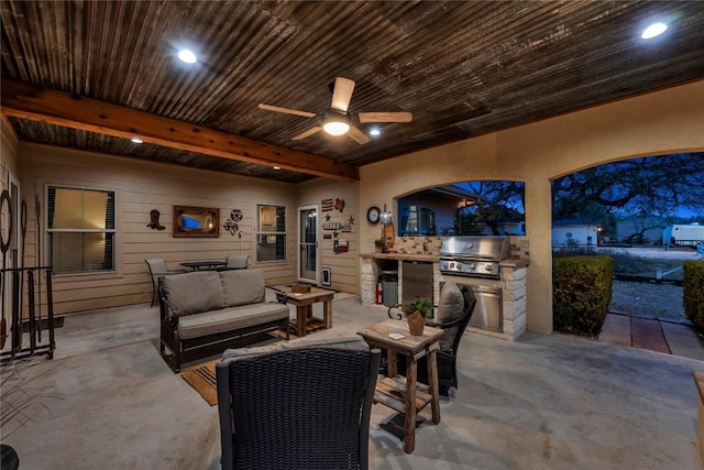 view of patio with area for grilling, outdoor lounge area, ceiling fan, and an outdoor kitchen