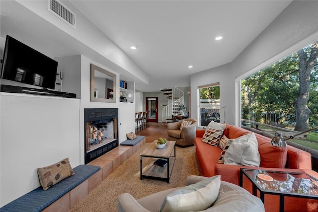 living room with a tiled fireplace