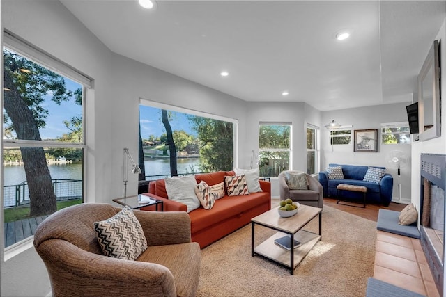 living room with a water view and a healthy amount of sunlight