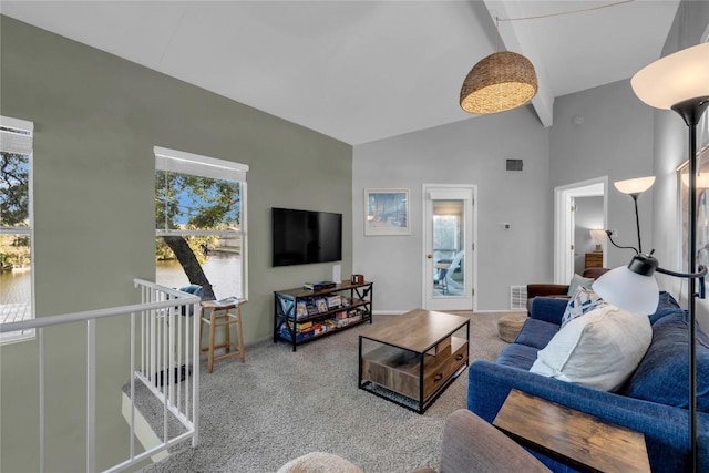 living room featuring beam ceiling, high vaulted ceiling, and carpet