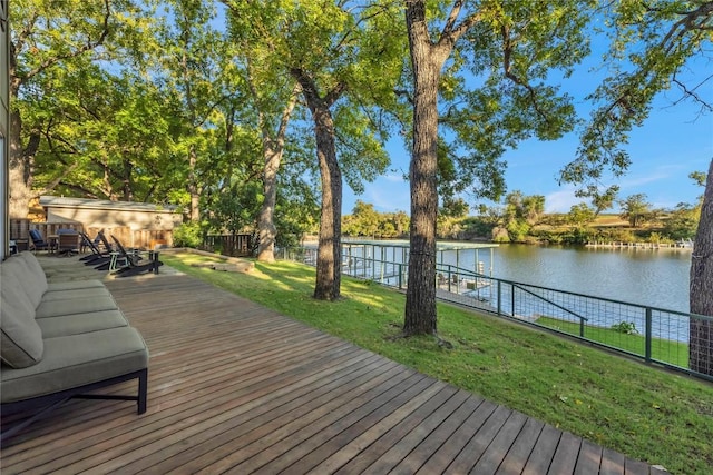 wooden terrace featuring a lawn and a water view