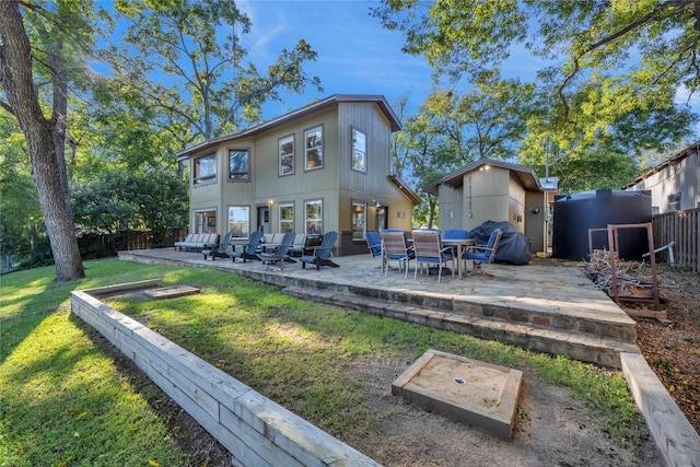 rear view of property with a patio and a yard