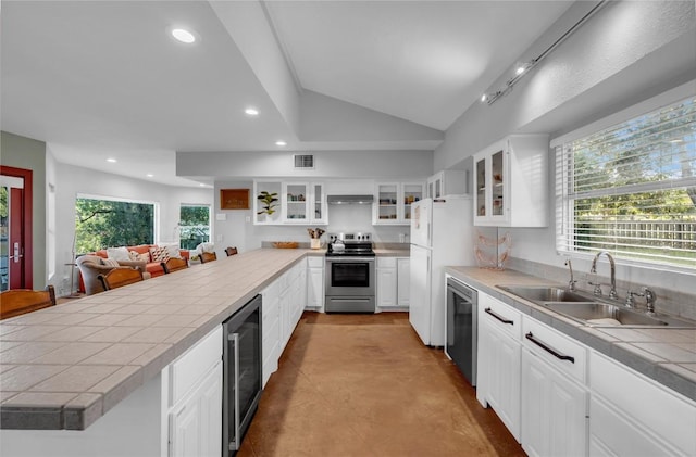 kitchen featuring white cabinetry, wine cooler, tile counters, and appliances with stainless steel finishes