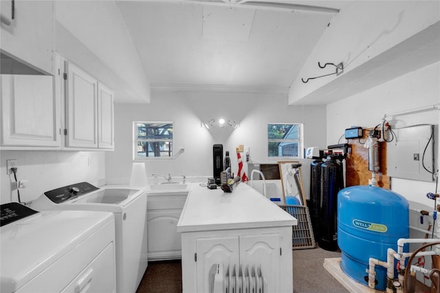 clothes washing area with cabinets, sink, and washer and dryer