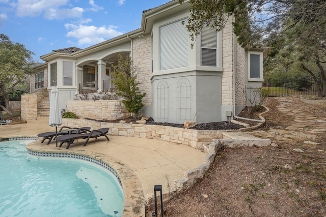 5019 Mcintyre Cir, Austin, TX 78734 - view of side of property featuring a patio area, an outdoor pool, and stucco siding