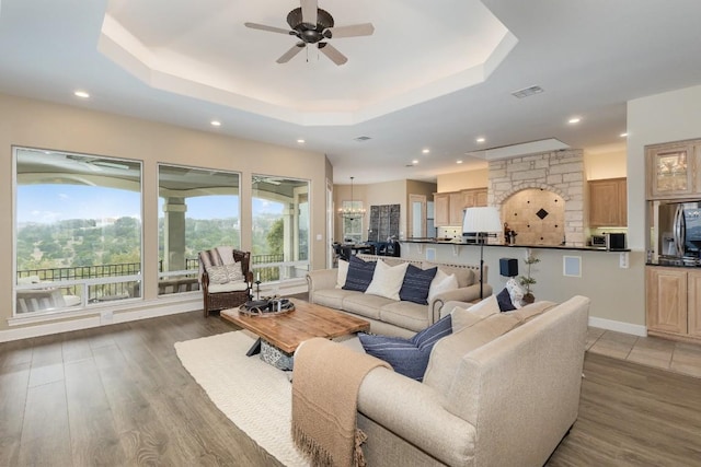 5019 Mcintyre Cir, Austin, TX 78734 - living room with a raised ceiling, a ceiling fan, recessed lighting, and light wood-type flooring