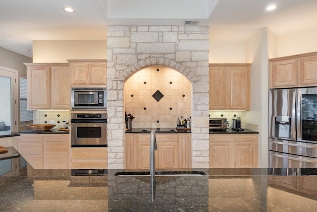 5019 Mcintyre Cir, Austin, TX 78734 - kitchen featuring stainless steel appliances, light brown cabinetry, decorative backsplash, recessed lighting, and dark stone counters