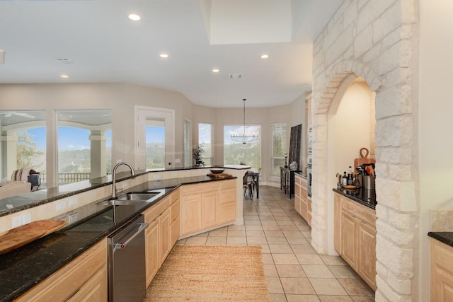 5019 Mcintyre Cir, Austin, TX 78734 - kitchen with light brown cabinets, stainless steel dishwasher, recessed lighting, light tile patterned floors, and dark stone countertops