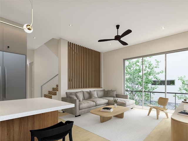 living room with ceiling fan and light hardwood / wood-style floors