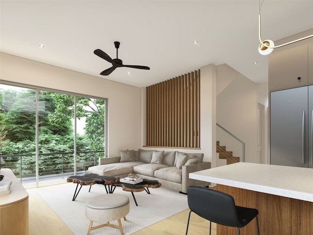 living room featuring light hardwood / wood-style flooring and ceiling fan