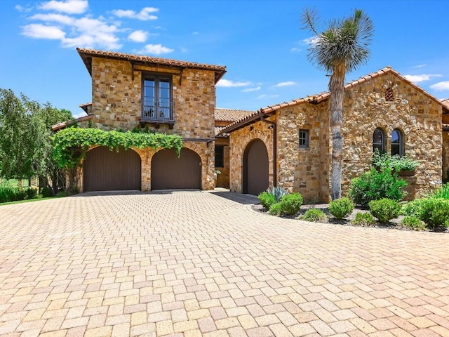 mediterranean / spanish house with a garage