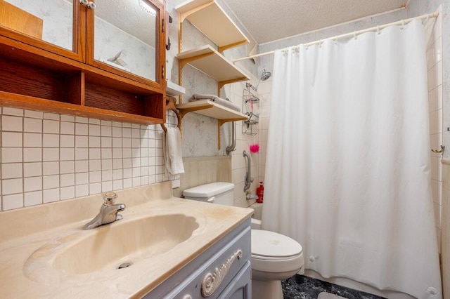 bathroom with vanity, toilet, curtained shower, and a textured ceiling