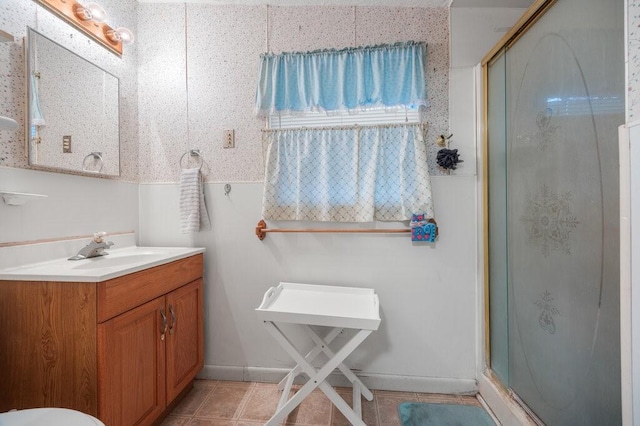 bathroom featuring vanity, an enclosed shower, and tile patterned floors