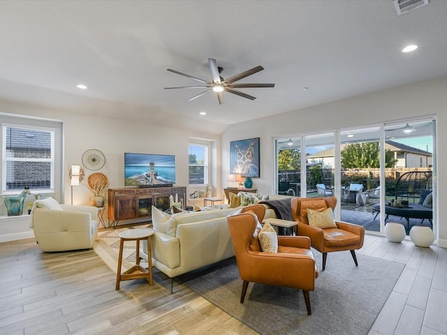 living room with light hardwood / wood-style flooring and ceiling fan