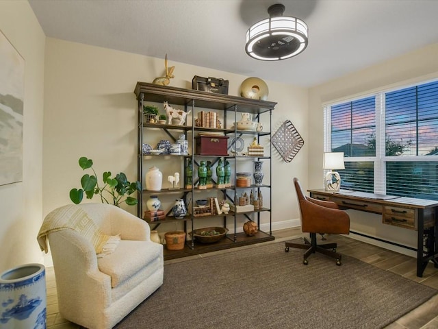 home office with baseboards and wood finished floors