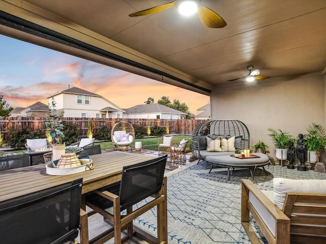 view of patio / terrace with outdoor dining area, a fenced backyard, an outdoor living space, and a ceiling fan