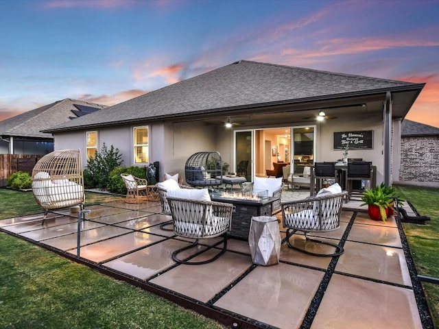 back of property featuring a shingled roof, ceiling fan, an outdoor hangout area, a patio area, and stucco siding