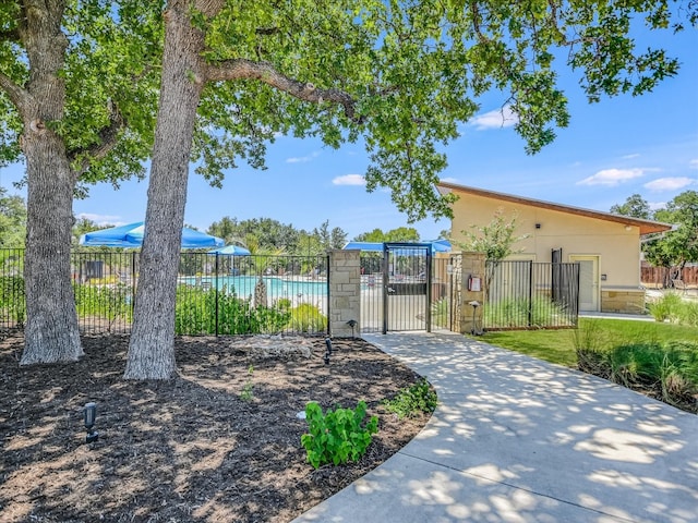 view of community with a gate and fence