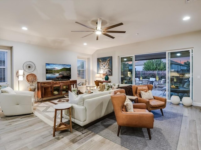 living room with light wood-type flooring, visible vents, ceiling fan, and recessed lighting