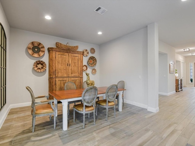 dining room featuring recessed lighting, light wood-type flooring, visible vents, and baseboards