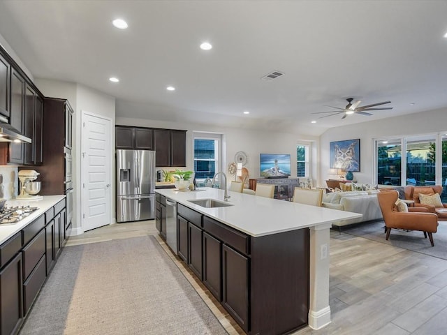 kitchen featuring visible vents, appliances with stainless steel finishes, light countertops, and a sink