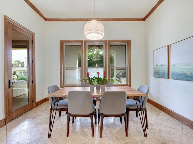 dining space featuring crown molding