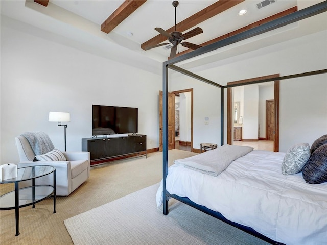 carpeted bedroom with beamed ceiling, ensuite bathroom, and ceiling fan