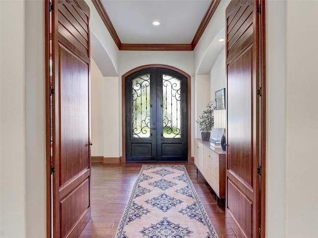 foyer featuring crown molding, dark hardwood / wood-style floors, and french doors