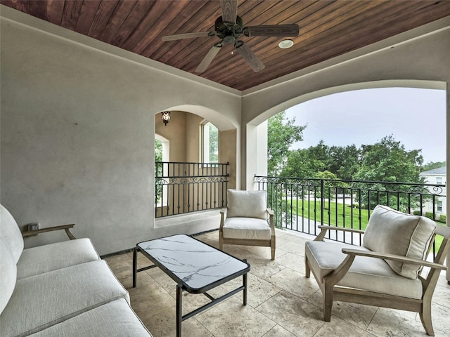 view of patio with ceiling fan, an outdoor hangout area, and a balcony